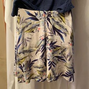 Lush decorative Tie front overlap skirt. Rear zipper.